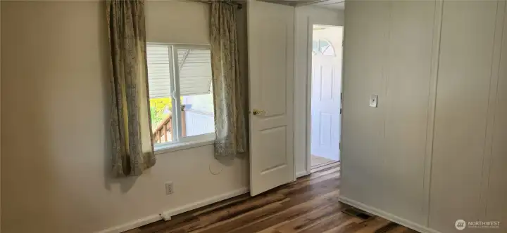 Outside the primary bedroom you can see your backdoor access from the hallway to the back porch and side yard gardens. Outside the primary bedroom you can see your backdoor access from the hallway to the back porch and side yard gardens.