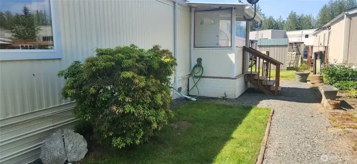 View of covered back porch with steps to your side yard and private walkway around the home. View of covered back porch with steps to your side yard and private walkway around the home.