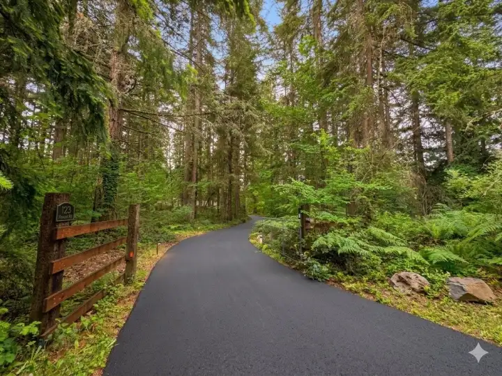 Gated entry and a new asphalt driveway lead you back to the house.