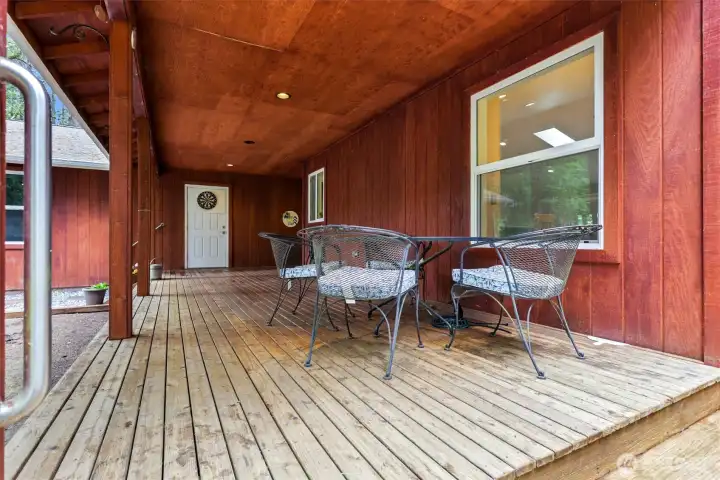 The covered deck wraps around from the front shown here, to the side of the house which the primary bedroom has direct access to.