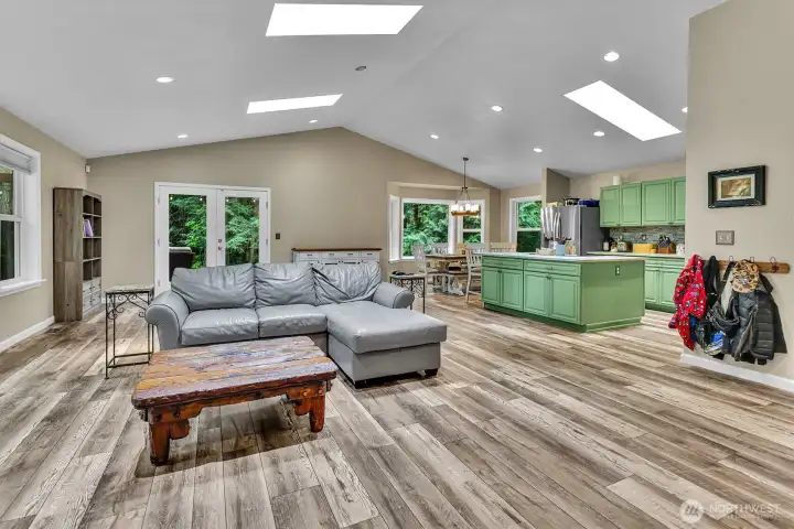 Another view of the great room open to the fully remodeled kitchen. Vaulted ceilings make this house feel even larger.