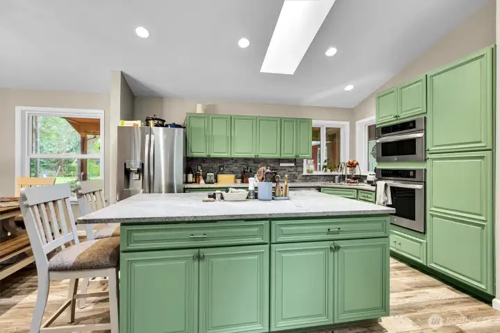Extra seating at the island, and more storage cabinets.