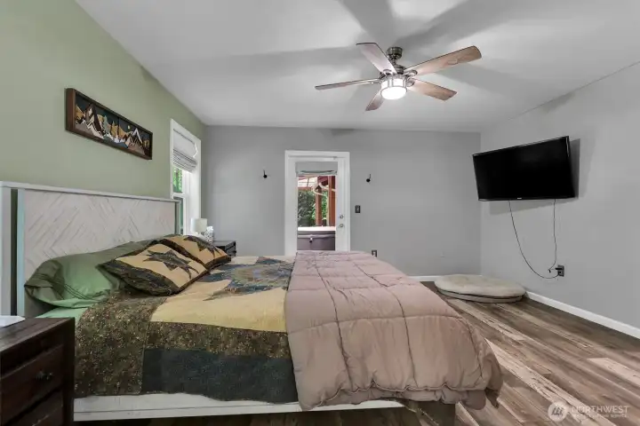 Spacious primary suite with access to the covered deck on the side of the house.