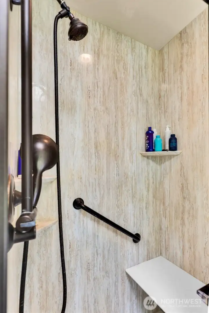 Primary shower with a built-in bench.