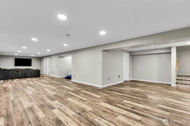 A larger view of the downstairs space. The 3/4 bath is to the left of this photo. It also has two rooms with closets currently used as offices.