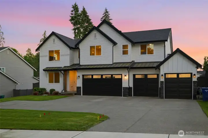 A picture-perfect dusk view of 505 SW 366th — soaring gables, board-and-batten siding, and a driveway built for four-plus vehicles. A picture-perfect dusk view of 505 SW 366th — soaring gables, board-and-batten siding, and a driveway built for four-plus vehicles.
