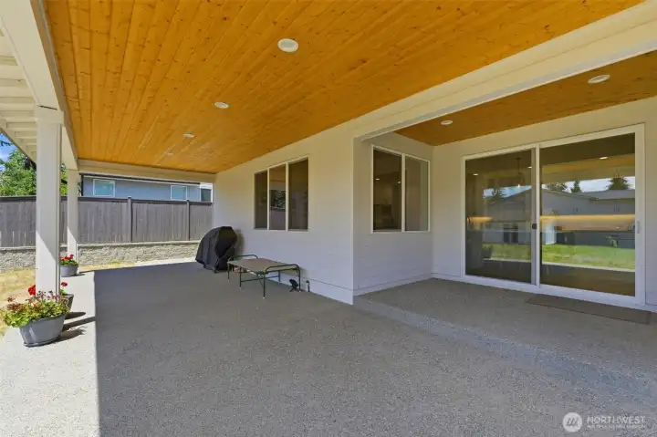The covered back patio, complete with TIG cover, offers year-round outdoor living overlooking the expansive backyard. The covered back patio, complete with TIG cover, offers year-round outdoor living overlooking the expansive backyard.