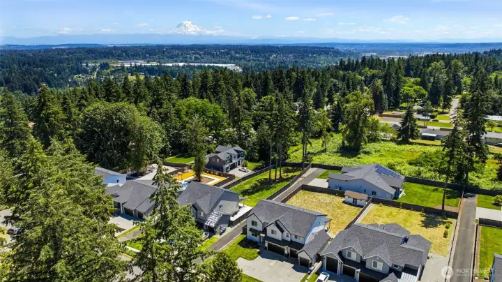 Aerial view showcasing the home's spacious lot within South Campus Estates, with stunning Mount Rainier views on the horizon. Aerial view showcasing the home's spacious lot within South Campus Estates, with stunning Mount Rainier views on the horizon.