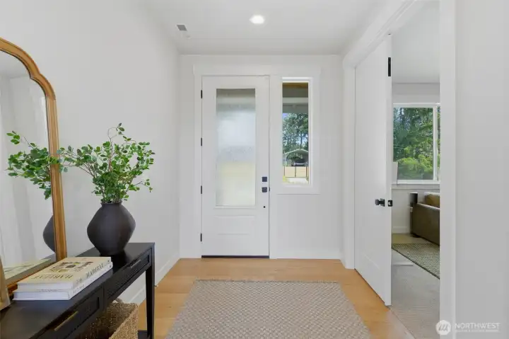A welcoming entry foyer with wide-plank flooring sets the tone, with sightlines through to the main living spaces. A welcoming entry foyer with wide-plank flooring sets the tone, with sightlines through to the main living spaces.