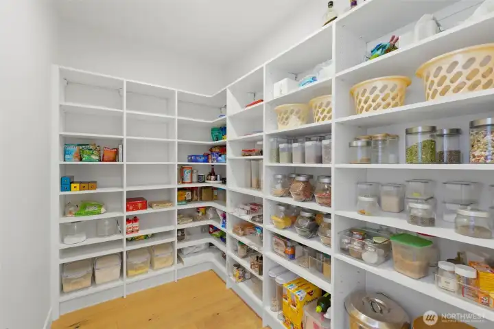 The expansive walk-in pantry offers wall-to-wall custom shelving — more storage than you'll know what to do with. The expansive walk-in pantry offers wall-to-wall custom shelving — more storage than you'll know what to do with.