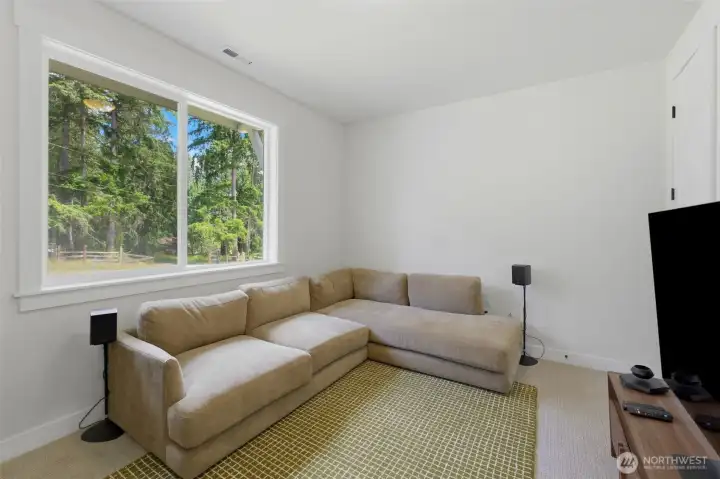 A versatile bonus room with peaceful wooded views — ready to become a media room, home theater, or second living space. A generous closet dwells here for a main level bedroom. A versatile bonus room with peaceful wooded views — ready to become a media room, home theater, or second living space. A generous closet dwells here for a main level bedroom.