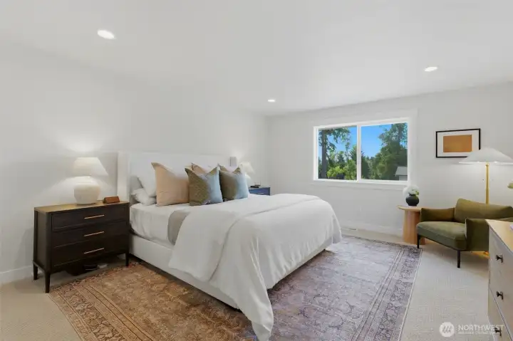 Bright, generously sized Primary bedroom with neutral tones and treetop views — a peaceful retreat. Bright, generously sized Primary bedroom with neutral tones and treetop views — a peaceful retreat.