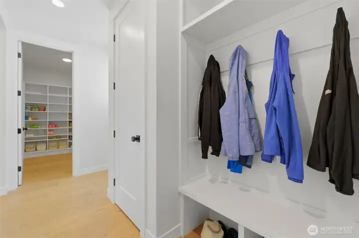 A built-in mudroom with bench seating and hooks keeps everyday gear organized, with direct access to the walk-in pantry. A built-in mudroom with bench seating and hooks keeps everyday gear organized, with direct access to the walk-in pantry.