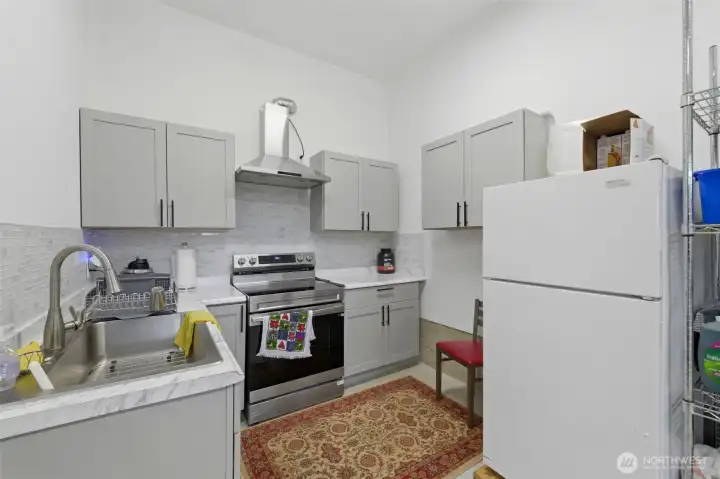 The seller-added second kitchen, conveniently located off the 4-car garage — full appliances and ample cabinetry make this space ready for ADU potential. The seller-added second kitchen, conveniently located off the 4-car garage — full appliances and ample cabinetry make this space ready for ADU potential.
