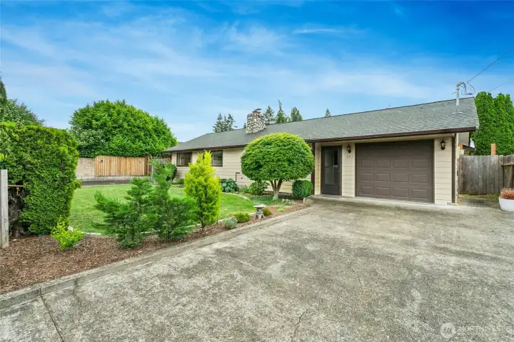 Entrance to the front of the home which consists of 3 bedrooms and 1.5 baths. Attached one car garage with laundry.