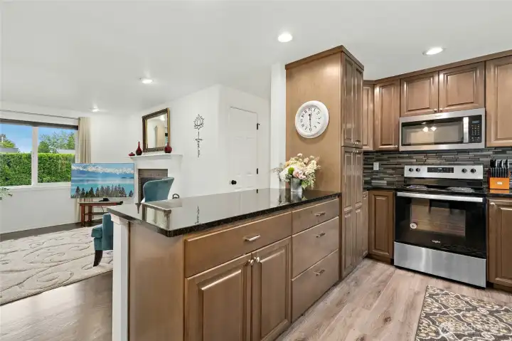 Stainless appliances and electric stove in this light-filled kitchen.