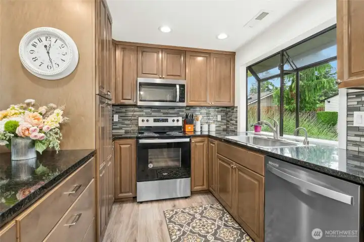 The large garden window looks out over the beautifully landscaped exterior and patio.