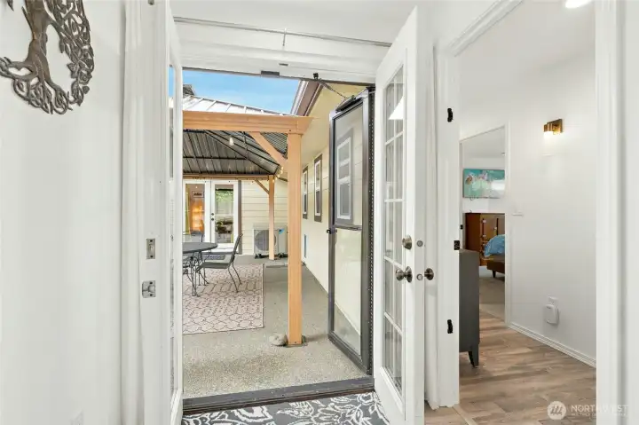 Just off the kitchen, step out to the covered patio. To the right, is the door to access the rest of the home, OR "unit #2."