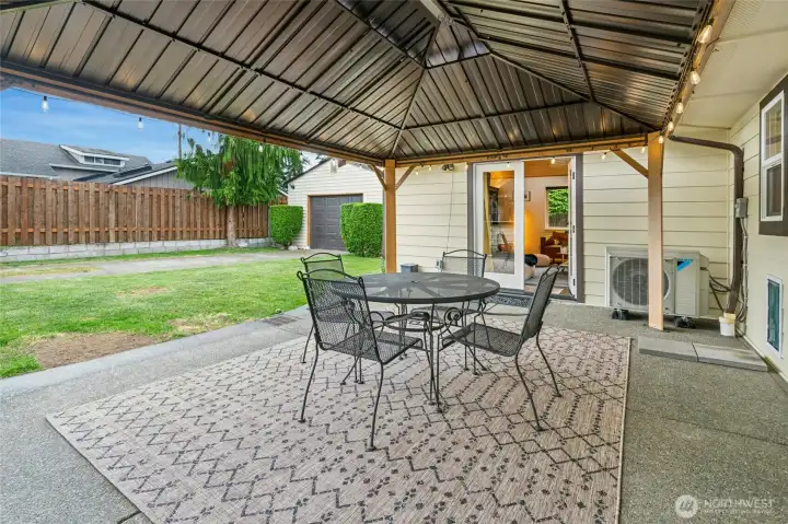 Beautiful covered courtyard with louvered pergola accessible from both areas of the home.
