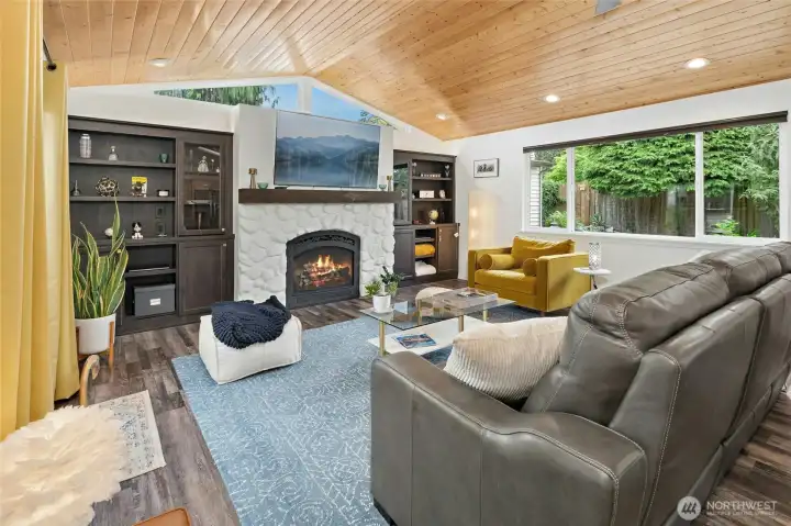 Beautiful living area with vaulted, tongue-in-groove ceiling and stately gas fireplace.