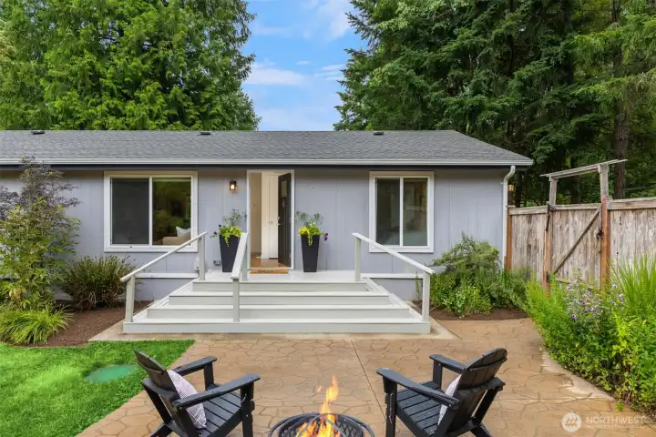 Most of the property is fenced. A convenient circular drive is just outside the gate to the right for easy access to the home. The porch transitions to the broad deck stairs adn front door. The tall windlows to the right provide views to the gardens from the primary suite. Most of the property is fenced. A convenient circular drive is just outside the gate to the right for easy access to the home. The porch transitions to the broad deck stairs adn front door. The tall windlows to the right provide views to the gardens from the primary suite.