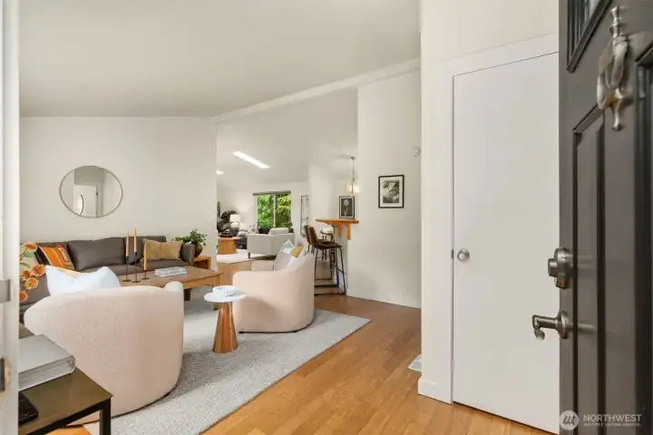 The entryway with the living room to the left and coat closet to the right. The entryway with the living room to the left and coat closet to the right.