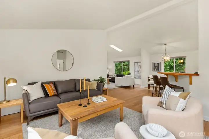 The living room with the kitchen to the right, the dining area and family room. Rich bamboo floors throughout the home. The living room with the kitchen to the right, the dining area and family room. Rich bamboo floors throughout the home.