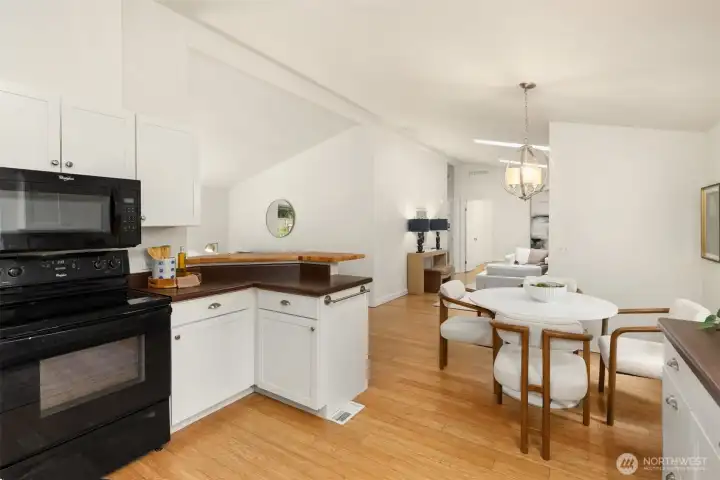 View across the kitchen to the dining room and distant family room. View across the kitchen to the dining room and distant family room.