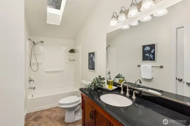 The full primary bath with skylight. The full primary bath with skylight.