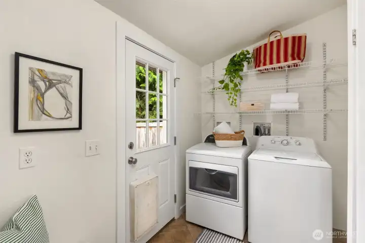The laundry room. The door opens to a large side yard with a garden shed. The laundry room. The door opens to a large side yard with a garden shed.