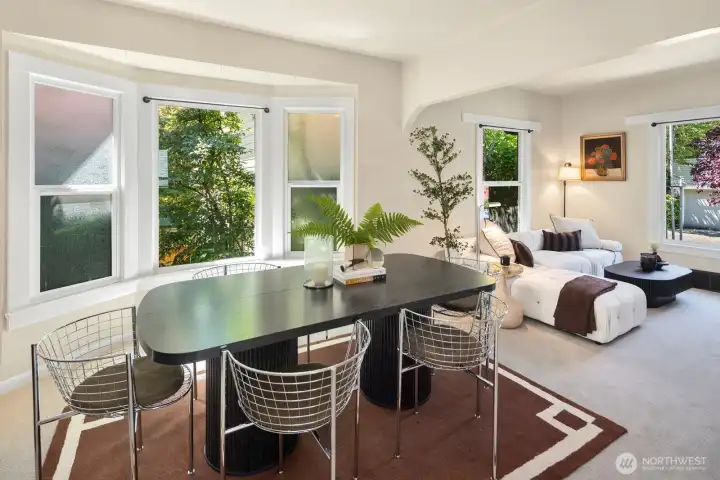 Host holiday dinners, game nights, or casual meals in a dining room filled with natural light and vintage character. Privacy glass purposefully included on side windows in dining area.