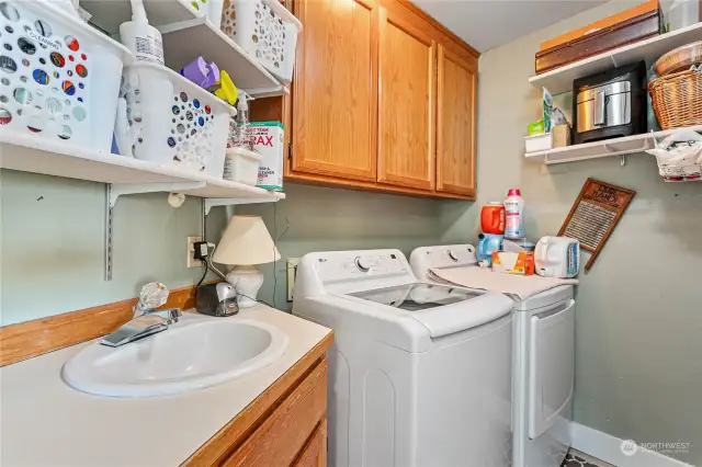 Laundry room with sink next to second bedroom.