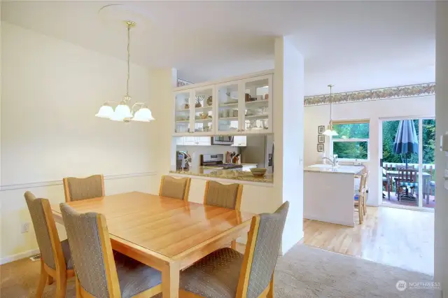 Formal dining room looking towards the kitchen. Notice the open pass through counter with see through cabinets above  that can be accessed from both kitchen and dining room.