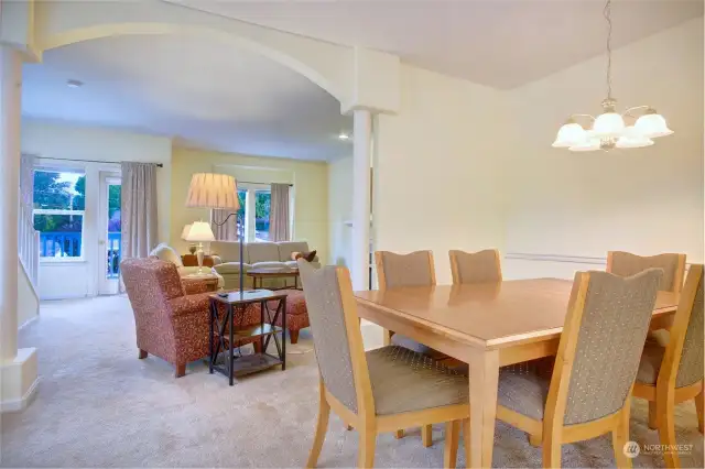 Dining room looking towards the living room with arched columned wall for separation.