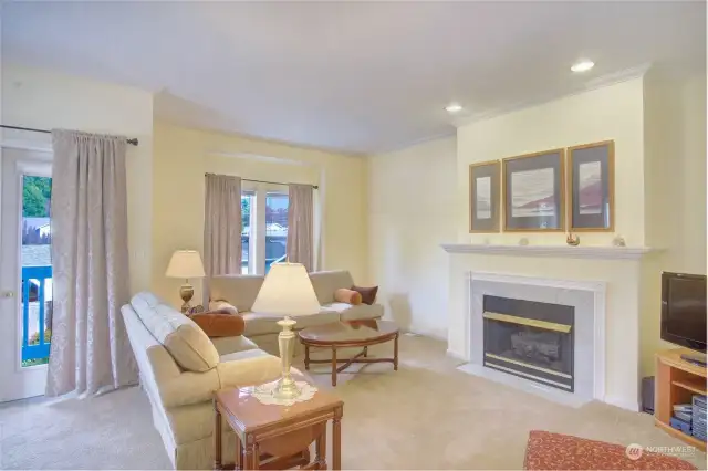 Living room with gas fireplace and door to the front deck.