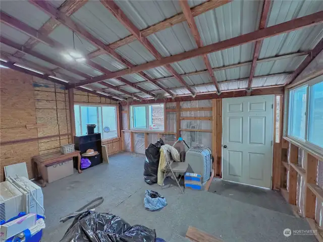 Enclosed front porch entry to home is great for mud room/storage