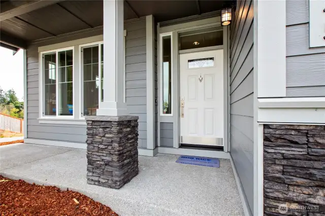 Stone columns on porch and garage panels. Photo for illustration only, not actual.