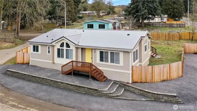 Front door and totally fenced.  Plenty of parking spaces. Metal roof.