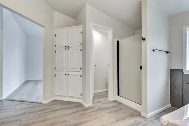 Lots of storage.  Door between the shower & cabinets is the toilet.