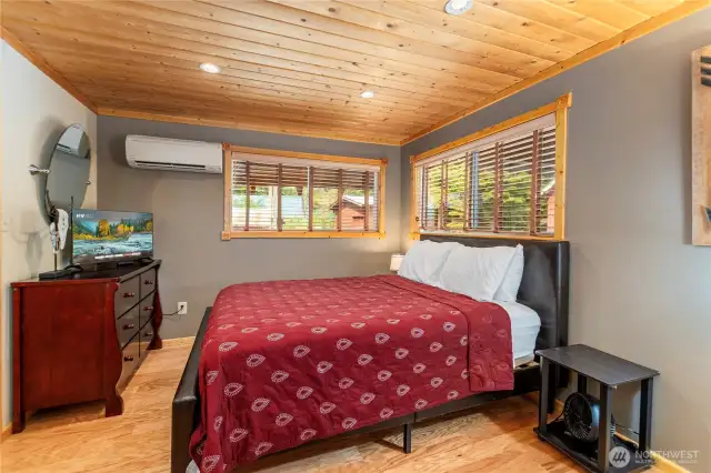 Main Floor Primary Bedroom with Comfort and Privacy    This main floor bedroom features a MINI-SPLIT HVAC for year-round comfort, two double-paned windows, and a walk-in closet to meet all your storage needs.