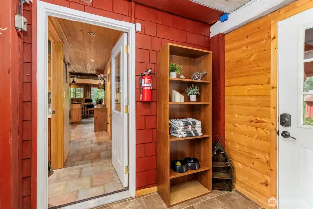 Functional Main Floor Foyer/Mud Room    This tiled entryway provides a convenient mudroom space, perfect for winter access, and helps keep your home organized and welcoming.