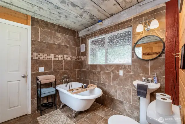 Charming Main Floor Second Bathroom    The second bathroom on the main floor includes a clawfoot tub, pedestal sink, and toilet—conveniently located between the foyer and laundry room.