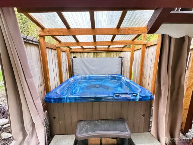 Private Covered Hot Tub for Relaxation    Unwind after a long day with a relaxing soak in the private, enclosed hot tub—perfect for summer evenings or cozy winter nights.