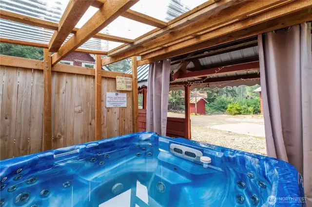 Private Covered Hot Tub for Relaxation    Unwind after a long day with a relaxing soak in the private, enclosed hot tub—perfect for summer evenings or cozy winter nights.