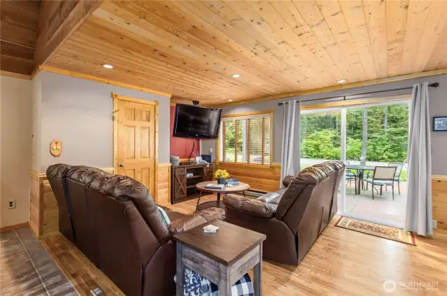Spacious Living Room with Entertainment Features    This living room comes complete with a game closet and an entertainment center with a mounted smart TV. All furnishings are included, making this home truly move-in ready.