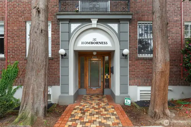 Glowing light-filled Corner Unit Home with Gracious and Spacious Living Room! The Hombroness is a handsome 1925 classic brick building right at the heart of Capitol Hill living. Classic & fanciful: inherent era charm, hi ceilings, charming breakfast nook, leaded glass built-in & a circular flr plan conveniently connecting the spaces. JUST REFRESHED w/new paint, lovely quartz counter w/undermount sink & faucets, refinished butcher block counter, blinds. Dues cover many expenses: heat,hot water,water,sewer,garbage. No rental cap, 30-day min rental allowed, pet-friendly, storage unit. 97 Walk Score: steps to lightrail, walk Dwtn or to SLU, bus/bike/rail to UW/SU. All the retail fun you could ever desire on Broadway, Pike/Pine, Volunteer Park!