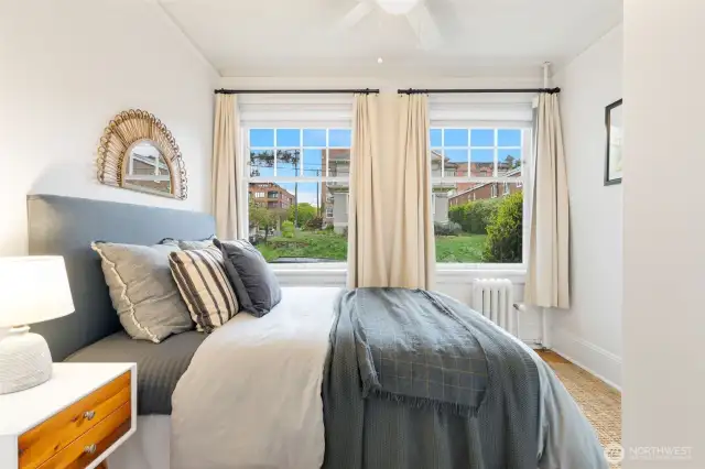 Lovely bedroom with up and down blinds + drapes.