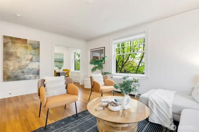 Gracious and spacious living room that glows with natural light from 2 sides in this corner home!