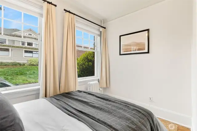 Lovely bedroom with up and down blinds + drapes.