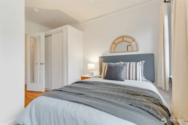 Lovely bedroom with up and down blinds + drapes.